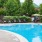 a pool with lounge chairs and umbrellas