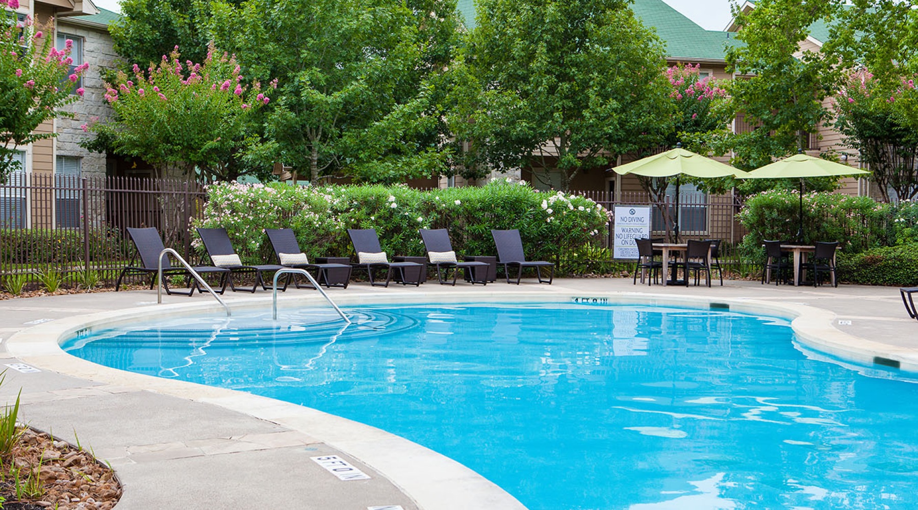 a pool with lounge chairs and umbrellas