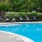a pool with lounge chairs and umbrellas