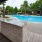 a kitchen island with a pool in the background