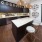 a kitchen island with barstools and a marble counter