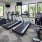a gym with treadmills and windows