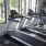 a gym with treadmills and windows