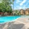 a pool with a building and trees in the background