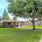 a lawn with a covered area and trees