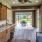 a covered deck area with seating and a kitchenette