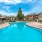 a pool with trees and a building in the backgroynd