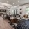 a lounge room with various seating and a kitchenette