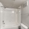 a shower with white tiles