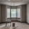 an empty living room with many windows