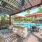 a covered grill and dining area by a pool