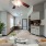 a living room with a couch and a kitchen bar beyond it