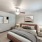 a bedroom with a bed and lamps and a window
