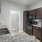 a kitchen with marble countertops a sink a fridge and a stovetop