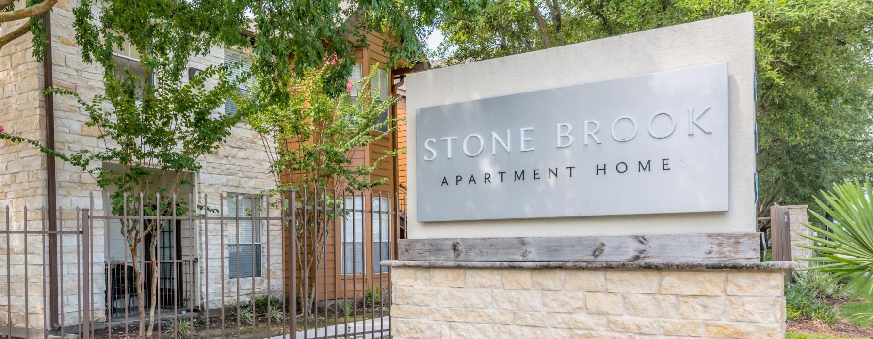 a sign on a wall that reads stone brook apartment homes