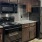 a kitchen with black appliances and dark wood cabinets