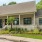 front of a building with a yard and parking