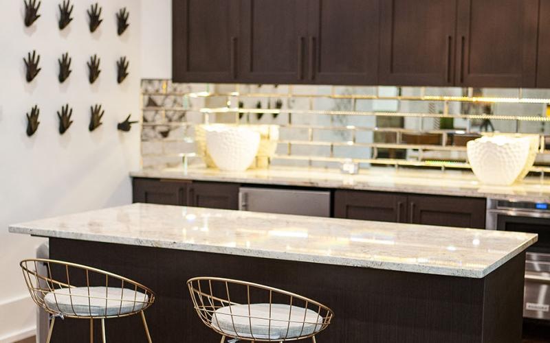 Access to resident-only features a kitchen with a bar and chairs